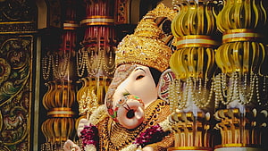 Ornate Golden Ganesha Deity Statue Adorned With Pearls And Temple Pillars HD wallpaper
