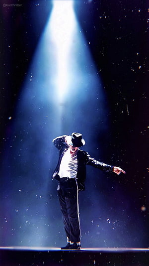Michael Jackson performing Billie Jean on stage under a dramatic spotlight HD phone wallpaper