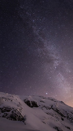 Milky Way Galaxy Arching Over Snow-Covered Mountain Ridge at Night HD phone wallpaper