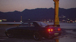 Black JDM Sports Car at Dusk with Glowing Taillights and Mountain Silhouette HD wallpaper