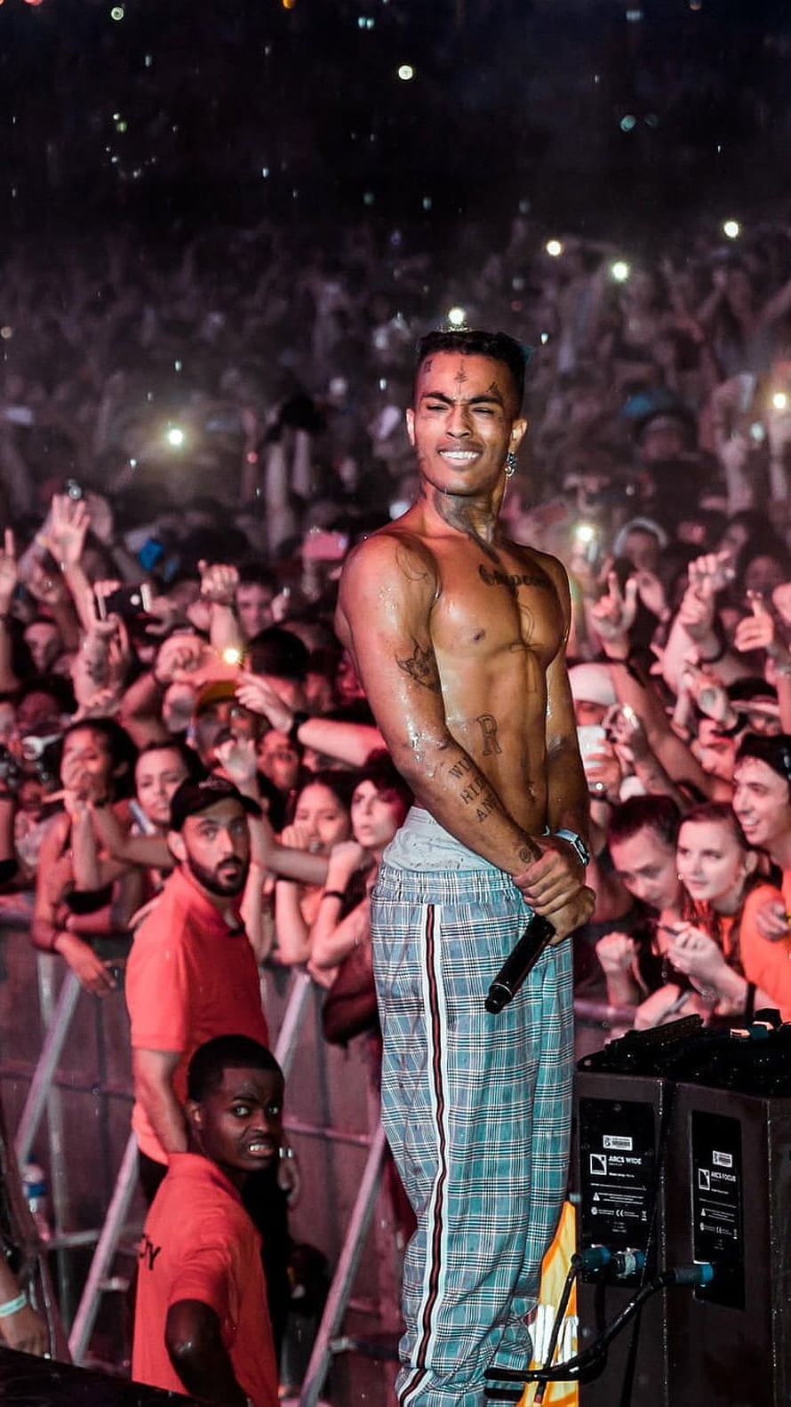 XXXTentacion performing shirtless on stage at a live concert with a large crowd HD phone wallpaper