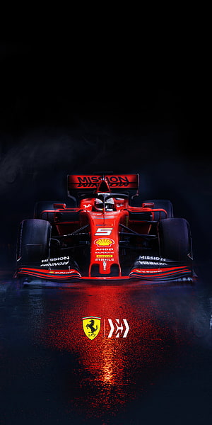 Ferrari Formula 1 Race Car Front View on Wet Track with Red Reflections HD phone wallpaper