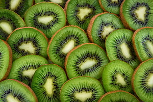 Fresh Sliced Kiwifruit Pattern With Vibrant Green Flesh And Black Seeds HD wallpaper