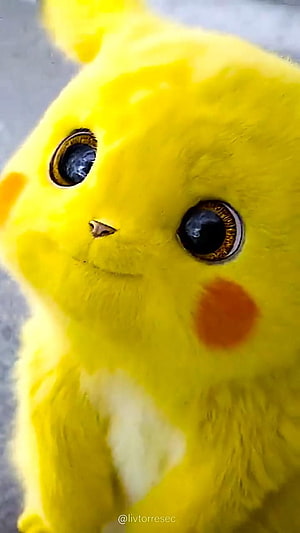 Close-up of a yellow Pikachu cat with large expressive eyes and red cheek patches HD phone wallpaper