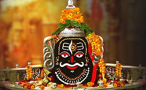 Mahakaleshwar Jyotirlinga adorned with marigold garlands and silver ornaments in Ujjain temple HD wallpaper