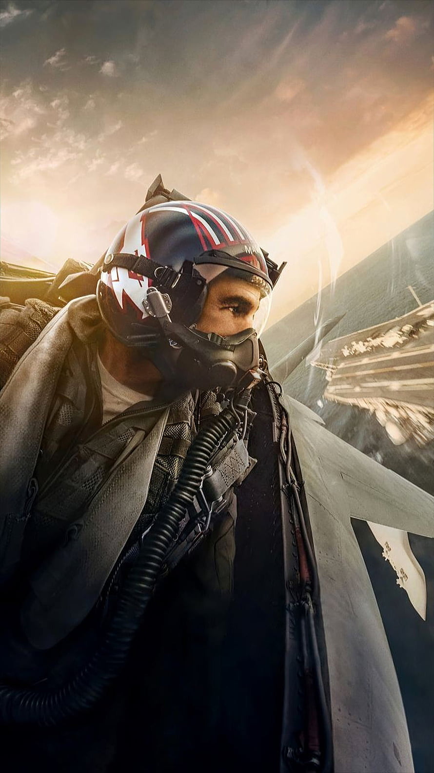 Maverick in flight gear beside a fighter jet wing against a golden sunset sky HD phone wallpaper