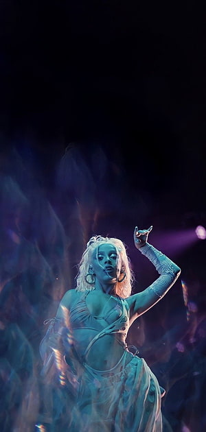 Doja Cat performing on stage in a white outfit with dramatic blue and purple lighting HD phone wallpaper