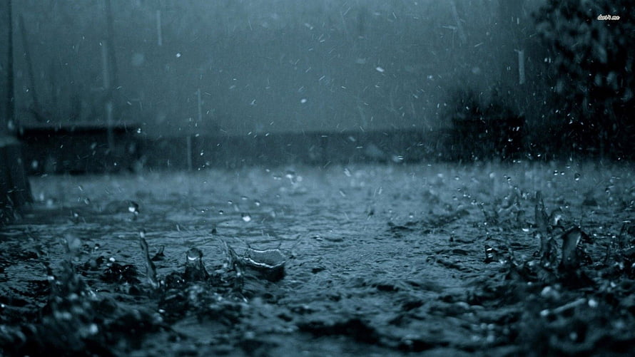 Moody Close-Up of Rain Droplets Splashing on Wet Ground in Cool Blue Tones HD wallpaper
