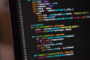 Close-up of Python source code with syntax highlighting on a dark editor background HD wallpaper