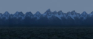 Snow-Capped Mountain Range at Dusk with Dark Foreground Meadow HD wallpaper