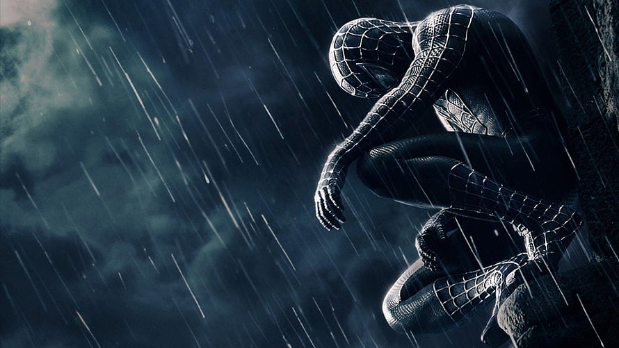 Spider-Man Crouching in Heavy Rain with Moody Blue Tones and Dramatic Lighting HD wallpaper