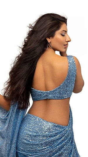 Vishnu Priya in a shimmering blue sequined saree with an open back design HD phone wallpaper