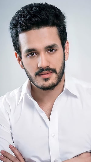 Akhil Akkineni Professional Portrait in White Shirt with Beard and Styled Hair HD phone wallpaper