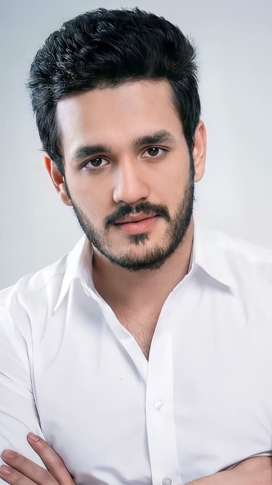 Akhil Akkineni Professional Portrait in White Shirt with Beard and Styled Hair HD phone wallpaper