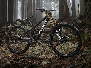 Trek Enduro Mountain Bike on Rocky Forest Trail in Misty Woods HD wallpaper