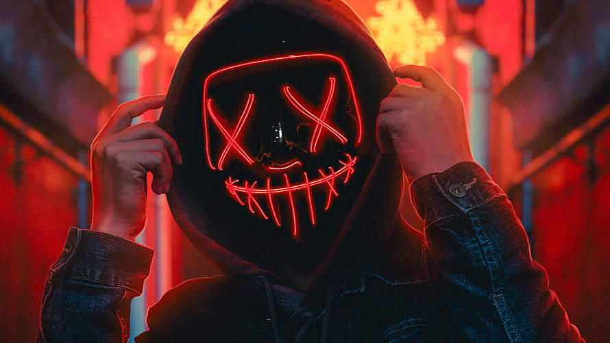 Person Wearing Glowing Red LED Mask in Dark Hoodie with Neon Background HD wallpaper