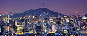 Seoul Cityscape at Dusk with Namsan Tower and Snow-Capped Hill HD wallpaper