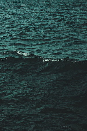 Dark Green Ocean Waves with White Foam Crests and Deep Teal Water Surface HD phone wallpaper
