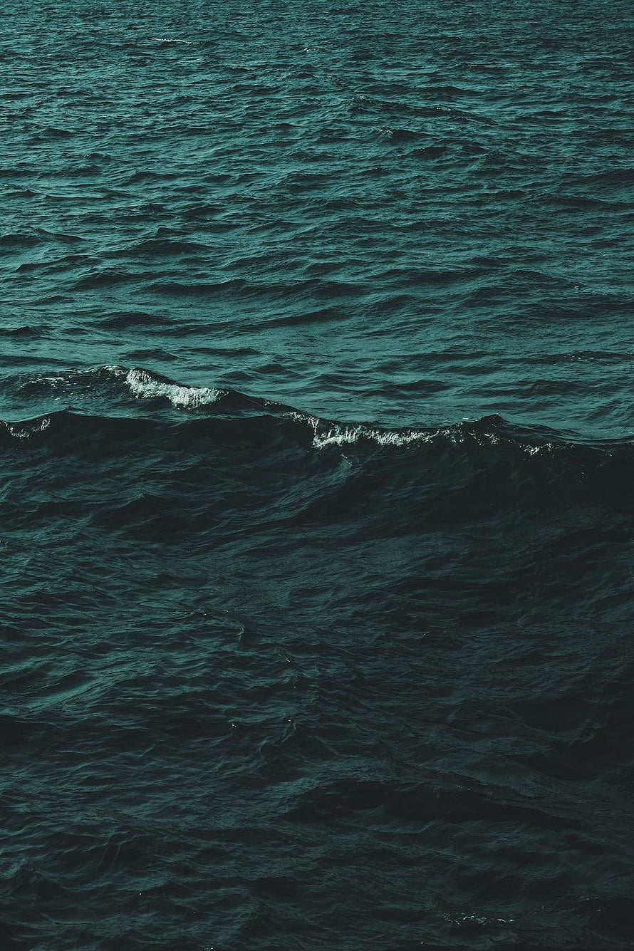 Dark Green Ocean Waves with White Foam Crests and Deep Teal Water Surface HD phone wallpaper