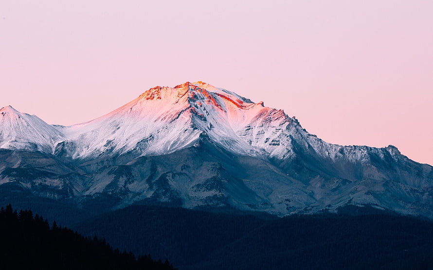 Snow-Capped Mountain Peak Bathed in Golden Sunset Light with Pink Sky HD wallpaper