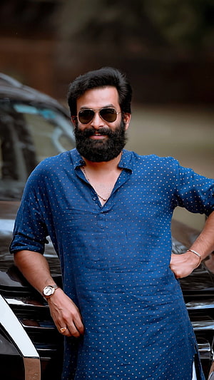 Prithviraj Sukumaran in a blue kurta with sunglasses and a full beard HD phone wallpaper