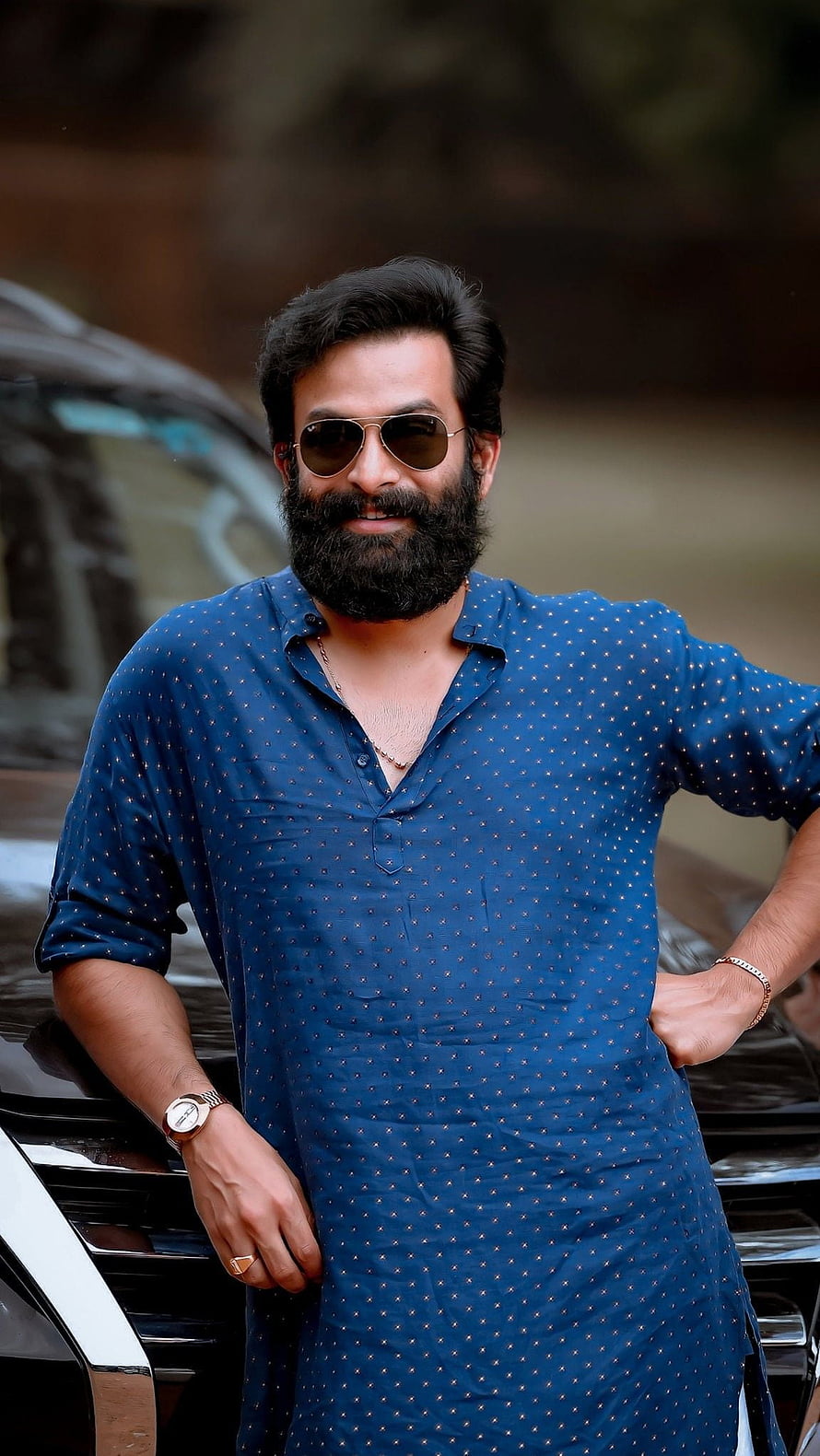 Prithviraj Sukumaran in a blue kurta with sunglasses and a full beard HD phone wallpaper