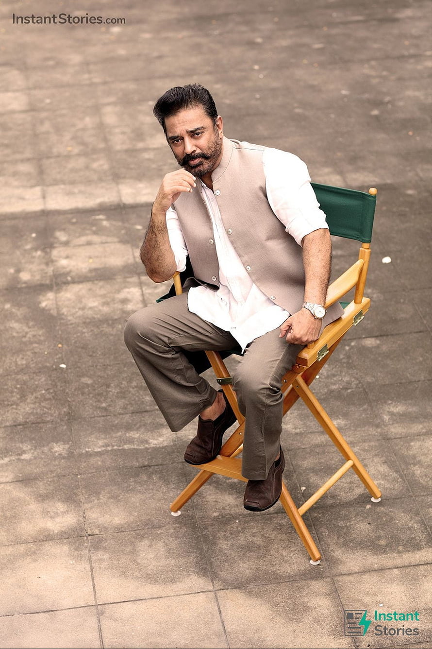 Kamal Haasan seated on a director's chair in a beige vest and white shirt HD phone wallpaper
