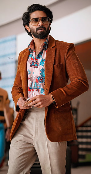 Dulquer Salmaan in a brown corduroy blazer and patterned shirt with aviator sunglasses HD phone wallpaper