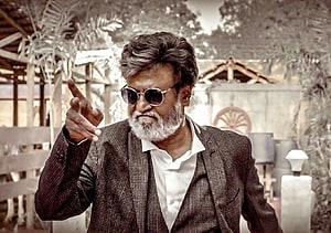 Rajinikanth in Kabali pointing forward in a checkered suit and sunglasses HD wallpaper