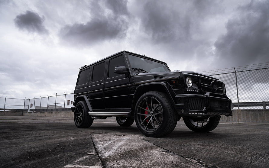 Black Brabus G63 G-Wagon SUV on Concrete Rooftop Under Stormy Sky HD wallpaper
