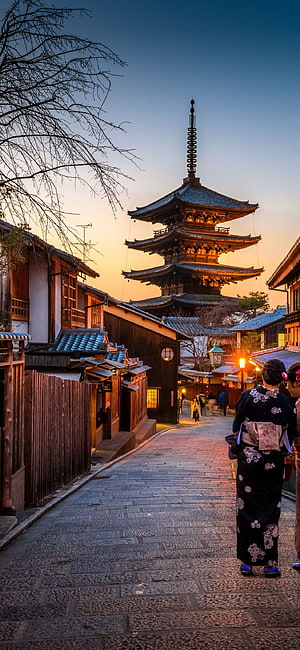 Woman in Kimono Walking Through Historic Kyoto Street at Sunset HD phone wallpaper
