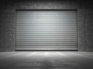 Minimalist Concrete Garage Interior With Closed Metal Roller Door HD wallpaper