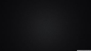 Minimalist Plain Black Background with Subtle Texture and Soft Vignette HD wallpaper