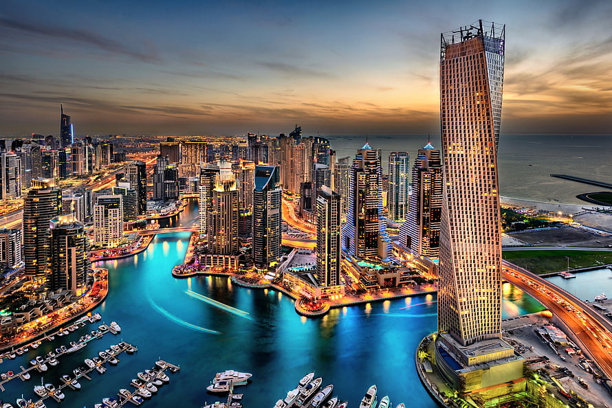 Dubai Marina skyline at dusk with illuminated skyscrapers and waterfront yachts HD wallpaper