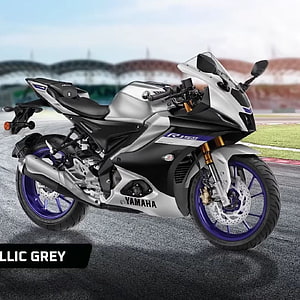 Yamaha R15M Sportbike in Metallic Grey with Blue Accents on a Race Track HD phone wallpaper