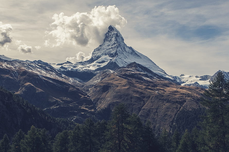 Matterhorn Peak Rising Above Alpine Forests and Snow-Capped Ridges HD wallpaper