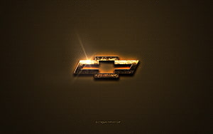 Chevrolet Golden Bowtie Emblem on Textured Brown Metal Surface HD wallpaper