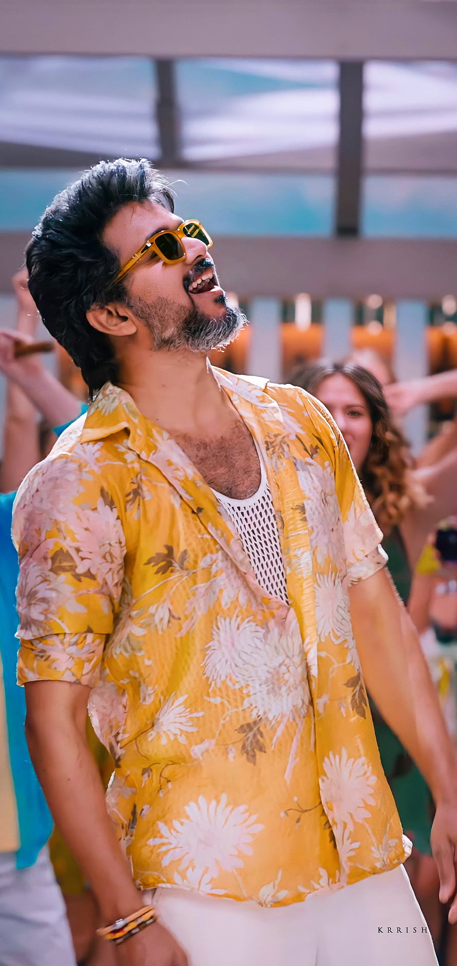 Thalapathy Vijay in a yellow floral shirt and sunglasses at a lively event HD phone wallpaper