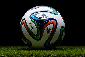 Adidas Brazuca 2014 FIFA World Cup Soccer Ball on Green Grass HD wallpaper