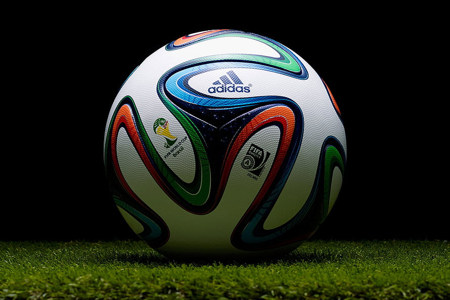 Adidas Brazuca 2014 FIFA World Cup Soccer Ball on Green Grass HD wallpaper