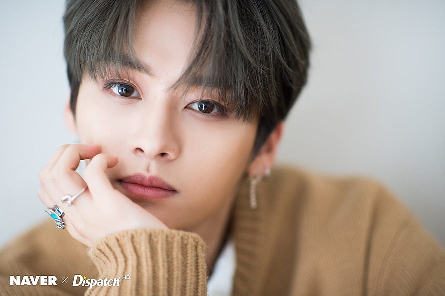 Lee Know from Stray Kids in a warm knit sweater with delicate jewelry and a soft studio portrait HD wallpaper