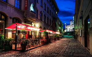 Helsinki Old Town Cobblestone Alley at Dusk with Restaurant Terrace and Church Spire HD wallpaper