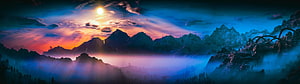 Misty Mountain Range at Sunset with Vibrant Orange and Blue Sky HD wallpaper