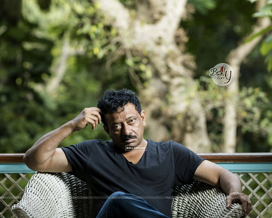 Ram Gopal Varma Portrait Sitting on Wicker Chair in Garden HD wallpaper