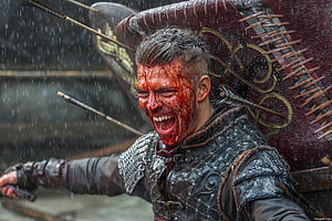 Ivar the Boneless Viking Warrior in Rainy Battle Scene with Shield and Blood HD wallpaper