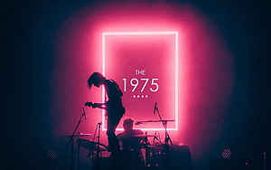 The 1975 Live Concert Stage with Neon Pink Backdrop and Silhouetted Guitarist HD wallpaper