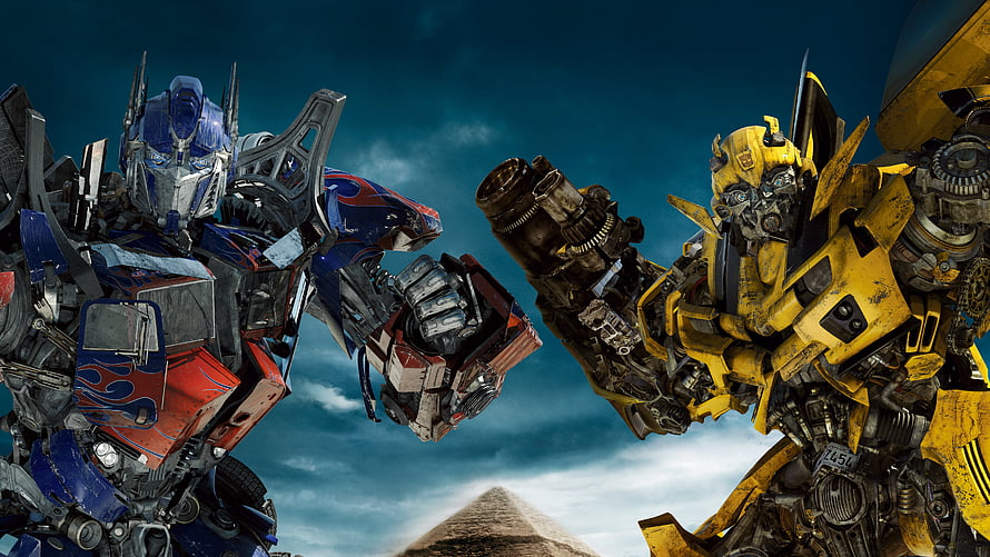 Transformers Optimus Prime and Bumblebee Fist Bump in Front of the Great Pyramid HD wallpaper