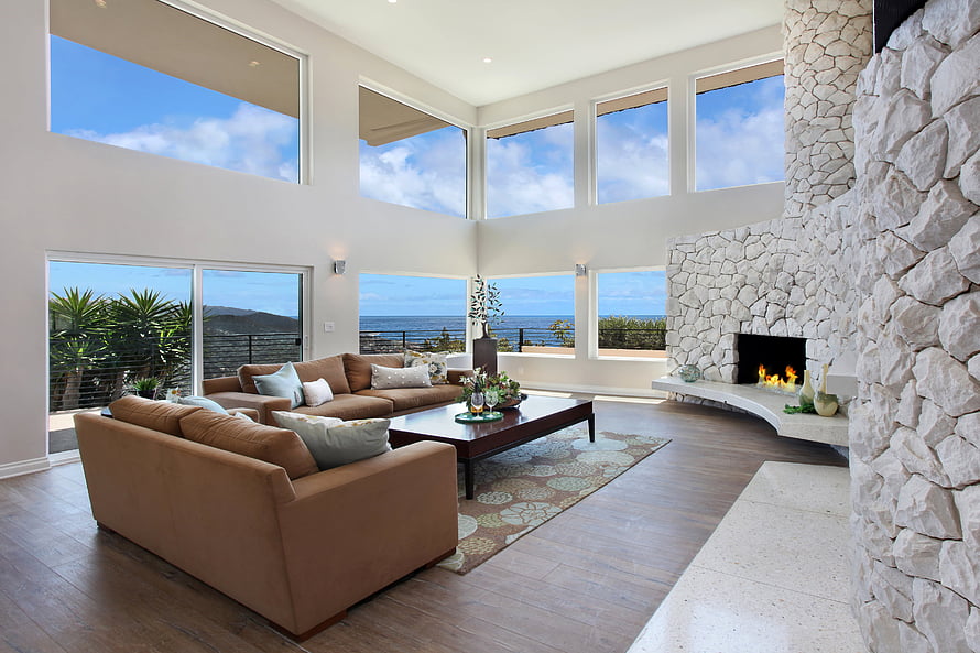 Spacious Modern Living Room With Stone Fireplace And Ocean View HD wallpaper