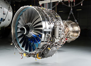 Large Turbofan Jet Engine Suspended in Industrial Hangar HD wallpaper
