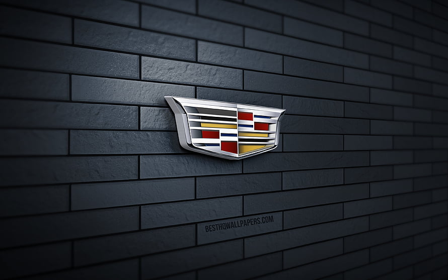Cadillac Emblem Mounted on Dark Gray Brick Wall with Dramatic Lighting HD wallpaper